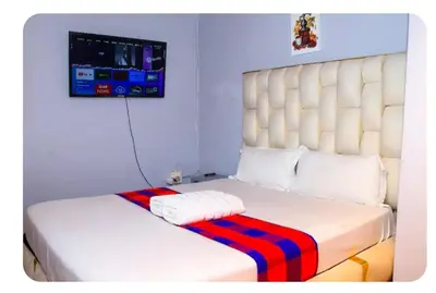 a white bed with a red and blue striped blanket on it at Amani Princely treat Silverton in Pretoria