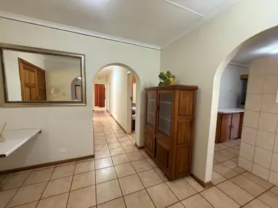 a bathroom with a sink and a mirror on a wall at Bushveld Inn Guest House in Mokopane