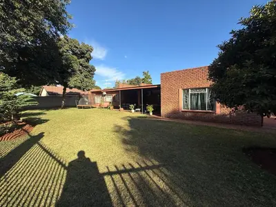 a shadow of a person standing in a yard at Bushveld Inn Guest House in Mokopane