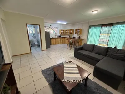 a living room with a couch and a table at Bushveld Inn Guest House in Mokopane