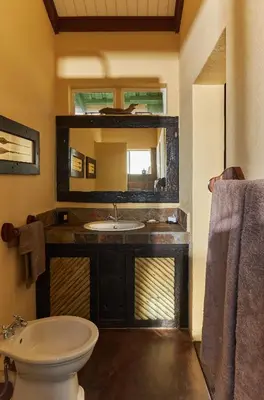 a bathroom with a sink and a mirror at Geelhoutkop Farm
