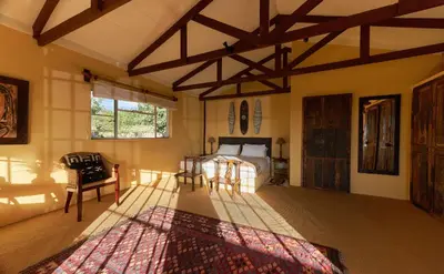 a bedroom with a bed and a window and a rug at Geelhoutkop Farm