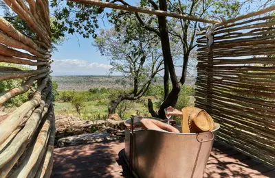 a bucket with a hat and a bottle of wine at Geelhoutkop Farm