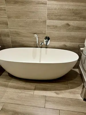 a white bath tub sitting in a bathroom at 2 beds, 2 bedrooms Family Suites 214 & 214-1 in Pretoria