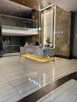 a lobby with a reception desk in a building at 2 beds, 2 bedrooms Family Suites 214 & 214-1 in Pretoria