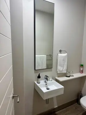 a bathroom with a white sink and a mirror at 2 beds, 2 bedrooms Family Suites 214 & 214-1 in Pretoria