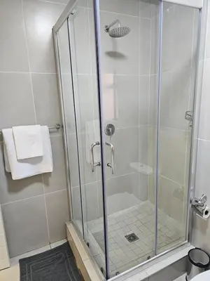 a shower with a glass door in a bathroom at Eland Ridge in Boksburg