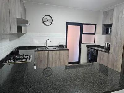 a kitchen with a sink and a counter top at Eland Ridge in Boksburg