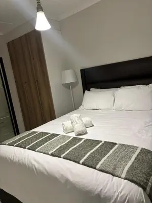 a bedroom with a bed with two towels on it at Aqua Haven-The Blyde in Pretoria
