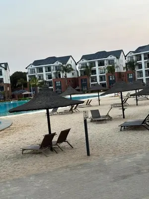 a group of chairs and umbrellas on a beach at Aqua Haven-The Blyde in Pretoria