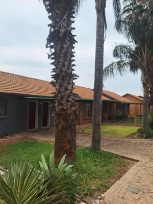 a palm tree in front of a house at 310 Bonnyvale in Kempton Park