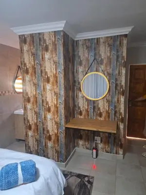 a bedroom with a bed and a mirror on a wall at 310 Bonnyvale in Kempton Park