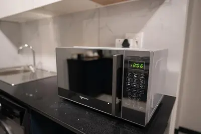 a microwave oven sitting on a counter in a kitchen at The Precinct Luxury Apartment - Waterfall in Kyalami
