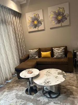 a living room with a couch and two tables at Menlyn Maine 1413 in Pretoria