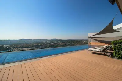 a swimming pool on a deck with a view of the water at Menlyn Maine 1413 in Pretoria