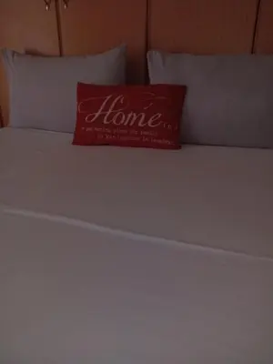 a red pillow sitting on top of a bed at Yana House in Polokwane