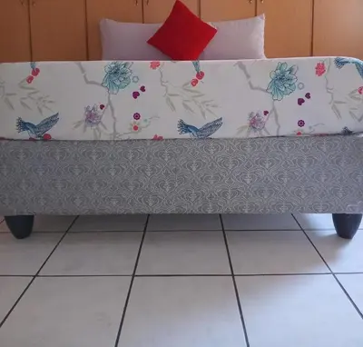 a bench with flowers on it in a room at Yana House in Polokwane