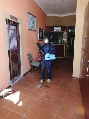 a man holding a gun in a room at Amigos Bed & Breakfast - No loadshedding in Nelspruit
