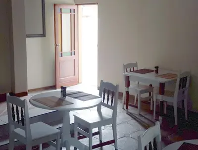 a dining room with a table and chairs and a door at Amigos Bed & Breakfast - No loadshedding in Nelspruit