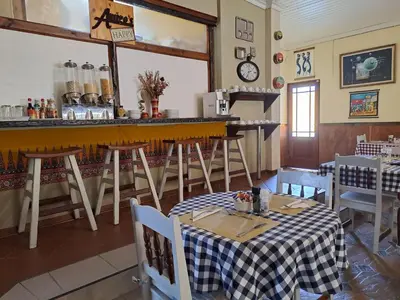 a restaurant with a table and chairs and a bar at Amigos Bed & Breakfast - No loadshedding in Nelspruit