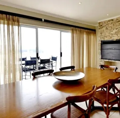 a dining room with a large wooden table and chairs at Elegant 4 ppl Villa nested in a picturesque town