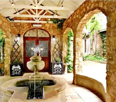 a stone building with a fountain in a courtyard at Elegant 4 ppl Villa nested in a picturesque town