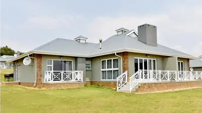 a large green house with a large porch at Elegant 4 ppl Villa nested in a picturesque town