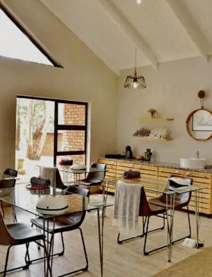 a dining room with chairs and a glass table at Elegant 4 ppl Villa nested in a picturesque town