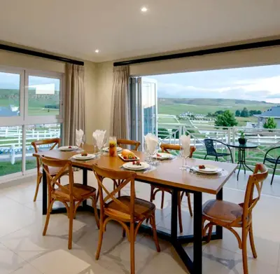 a dining room with a table and chairs and a large window at Elegant 4 ppl Villa nested in a picturesque town