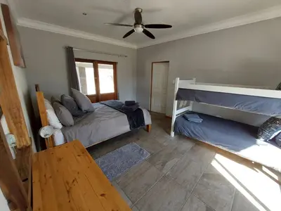 a bedroom with two beds and a ceiling fan at Oryx Lodge in Brits
