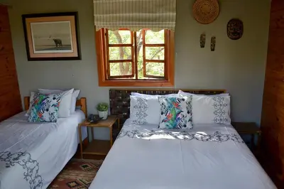 a bedroom with two beds and a window at Kudusdrift Farmstay in Vaalwater