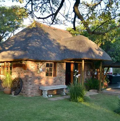 a brick house with a bench in front of it at Kudusdrift Farmstay in Vaalwater