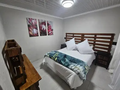 a bedroom with a bed in a room at Sally's Place in Boksburg