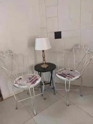 two chairs and a table with a lamp on it at Sally's Place in Boksburg