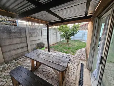 a wooden picnic table and a bench on a patio at Sally's Place in Boksburg