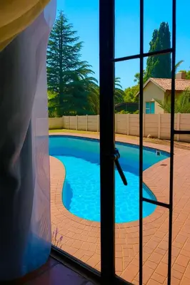 a view of a swimming pool through a window at Inocova Fly in Kempton Park