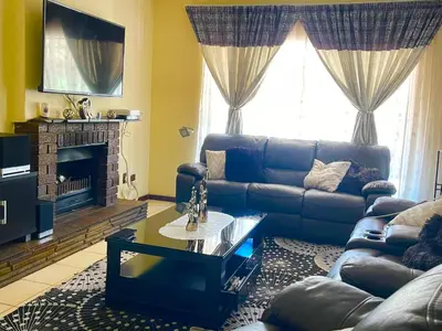 a living room with a couch and a fireplace at Inocova Fly in Kempton Park