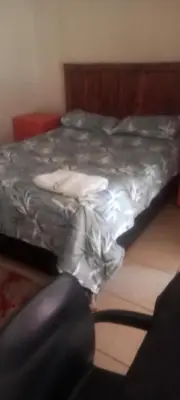 a bed in a room with a bedskirtspectspectspects at Limelight in Polokwane