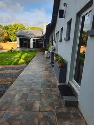 a stone walkway leading to a house at The Cypress Guesthouse in Pretoria