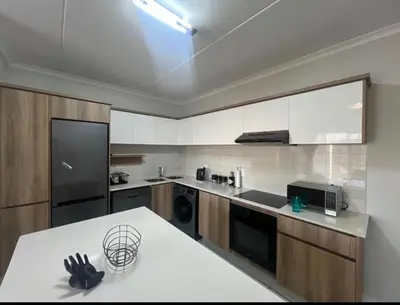 a kitchen with a white counter top in a room at The Blyde Apartment in Pretoria
