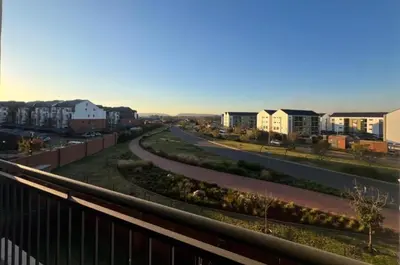 an empty road in a city with buildings at The Blyde Apartment in Pretoria