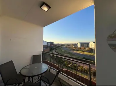 a balcony with a table and chairs and a view at The Blyde Apartment in Pretoria