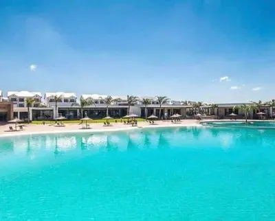 a large pool with blue water in a resort at The Blyde Apartment in Pretoria