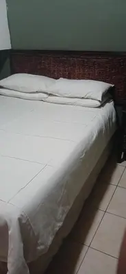 a large white bed with white sheets and pillows at 16 Besembos contractors accommodation in Witbank