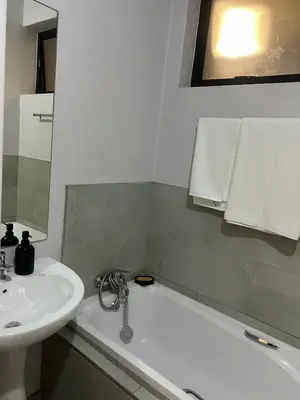 a bathroom with a sink and a bath tub and a sink at Modern Apartment in Centurion in Centurion
