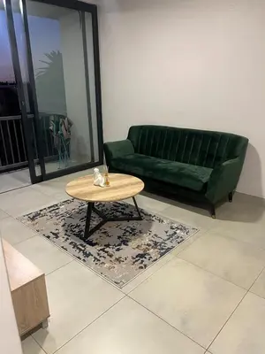 a living room with a green couch and a coffee table at Modern Apartment in Centurion in Centurion