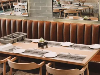 a table with plates and napkins on it in a restaurant at ANEW Resort Hazyview Kruger Park in Hazyview