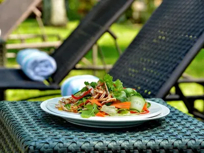 a plate of salad sitting on a table at ANEW Resort Hazyview Kruger Park in Hazyview