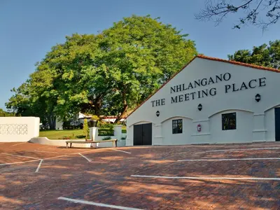 a white building with a sign on the side of it at ANEW Resort Hazyview Kruger Park in Hazyview