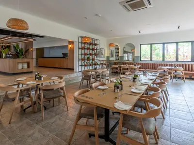 a dining room with wooden tables and chairs at ANEW Resort Hazyview Kruger Park in Hazyview